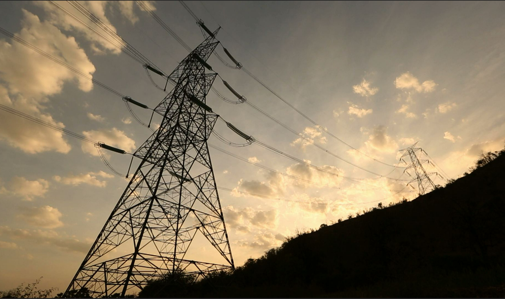 transmission lins and sunset behind